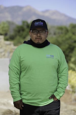 A man wearing a green long - sleeve shirt.